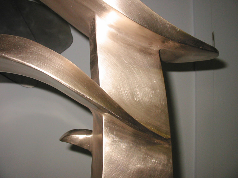 Closeup of Optimism showing the smoothly finished fabricated bronze.